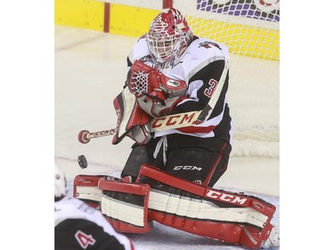 Moose Jaw Warriors' Zach Sawchenko makes a big save during game action against the Calgary Hitmen at the Saddledome in Calgary, on October 15, 2015.