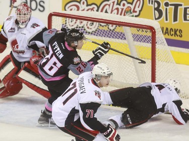 Calgary Hitmen's  Andrew Fyten gets a cross checking penalty after this move against Moose Jaw Warriors' score during game action at the Saddledome in Calgary, on October 15, 2015.