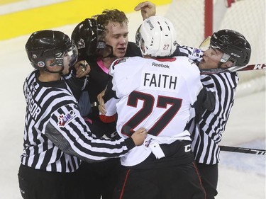 Calgary Hitmen's Loch Karnaukov has words with Moose Jaw Warriors' Tanner Faith during game action at the Saddledome in Calgary, on October 15, 2015.