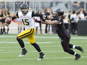 Hamilton Tiger-Cats quarterback Jeff Mathews, seen brushing off Ottawa Redblacks linebacker Travis Brown during a pre-season game, will be at the controls when the team hosts the Calgary Stampeders on Friday night.