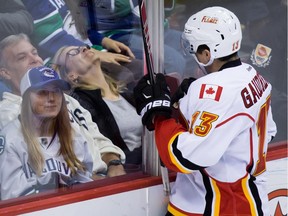 Calgary Flames' Johnny Gaudreau celebrates after scoring the winning goal against the Vancouver Canucks during the overtime period of an NHL hockey game in Vancouver, B.C., on Saturday, October 10, 2015.