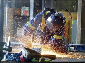 HC Piper structural fitter welder Peter Greer, seen on June 21, 2010, ground down the platform of  structure being built for Alberta's oilsands at the Calgary manufacturing facility.