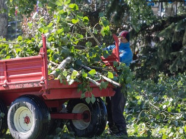 Ground crews work to remove fallen trees and branches from the Earl Grey Golf Club in Calgary.