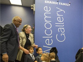 Mike, left and Linda Shaikh, with their grandchildren, unveil the welcome gallery named in their honour after their $1-million donation to the Calgary Public Library Foundation in Calgary, on October 3, 2015.