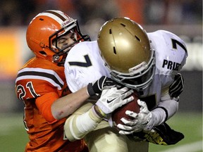 Notre Dame's Avery McCuaig, right, is tackled by St. Francis' Kaedon Armstrong during their Div. 1 city championship match last November. The two city powerhouses will renew acquaintances on Friday (4 p.m., McMahon Stadium).