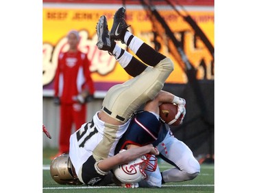 Brandon Mellen of the Huskies takes down Colts Cole Meyer  in the first quarter as the Calgary Colts played host to the Edmonton Huskies in Prairie Junior Football League at McMahon Stadium on September 26, 2015.