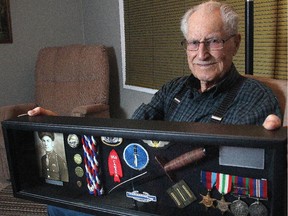 Bernard Cooper holds the case containing his medals and mementoes from his days in World War II fighting in Europe with the Devil's Brigade,