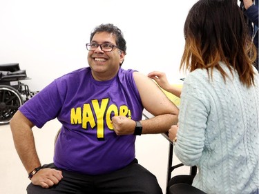 Mayor Naheed Nenshi gets ready to get his annual influenza immunization shot at the flu clinic in Northgate in Calgary on October 21, 2015.