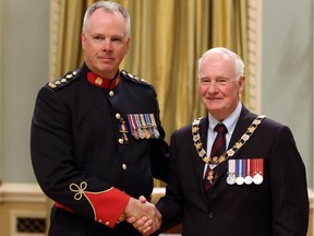Deputy Chief Roger Chaffin of the Calgary Police Service, is invested as Officer to The Order of Merit of the Police Forces by Governor General David Johnston during a ceremony at Rideau Hall, the official residence of the Governor General in Ottawa, Friday Sept. 18, 2015.
