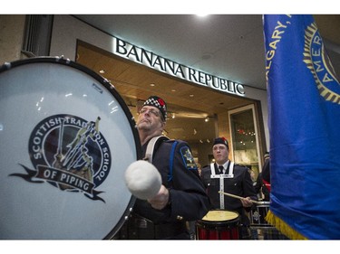 A pipe band marches through Chinook Mall to launch the poppy fund in Calgary, on October 31, 2015.