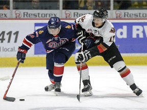 Regina Pats forward Connor Hobbs is shadowed by Calgary Hitmen forward Beck Malenstyn during their WHL meeting on Sunday. Calgary won 3-0.