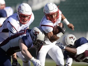 Regina Thunder linebacker Jarrett Seck (#21) tackles Calgary Colts running back Xavier Ramsay (#1) at Mosaic Stadium in Regina on Sunday.