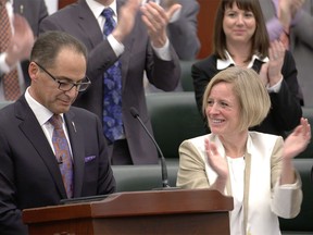 Finance Minister Joe Ceci receives applause after reading the NDP's 2015 Alberta budget at the Alberta Legislature in Edmonton on Oct. 27, 2015.