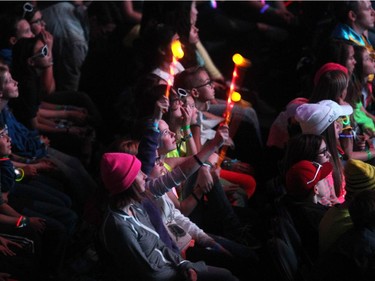 Young crowd members listened as rapper Kardinal Offishall spoke to the crowd during WE Day in Calgary at the Scotiabank Saddledome on October 27, 2015.