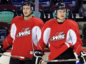 New Calgary Hitmen players Jackson Houck, left and Jakob Stukel practise with the team at the Scotiabank Saddledome on Wednesday.