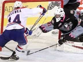 Spokane Chiefs' Adam Helewka scores on Calgary Hitmen netminder Cody Porter in Spokane's 6-3 win at the Scotiabank Saddledome on Thursday.