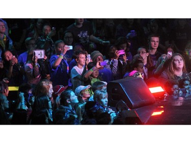 Young crowd members took photos as Canadian singer Francesco Yates performed to the crowd during WE Day in Calgary at the Scotiabank Saddledome on October 27, 2015.