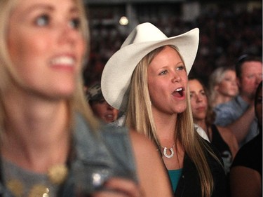 Fans stand as Paul Brandt takes the stage Friday night October 2, 2015 at the Saddledome as part of the Road Trip with Dean Brody.