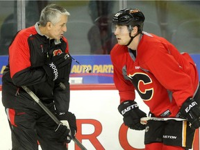 Calgary Flames head coach Bob Hartley, left, gives some instruction to centre Sam Bennett as the team runs through drills on Tuesday ahead of Wednesday's home opener against the Vancouver Canucks.
