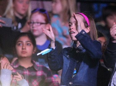 A young WE Day participant danced to the music during WE Day in Calgary at the Scotiabank Saddledome on October 27, 2015.