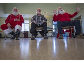 Santas practice their "sitting" while at Santa Claus school in Calgary, on October 17, 2015.