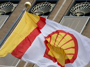 In this Monday, April 7, 2014 file photo, a flag bearing the company logo of Royal Dutch Shell, an Anglo-Dutch oil and gas company, flies outside the head office in The Hague, Netherlands.