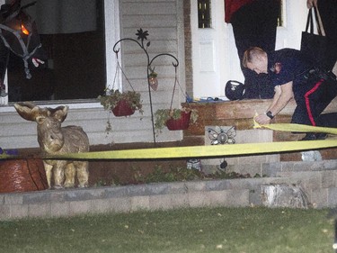 Police search for evidence and tape off several areas after a shooting on Hendon Dr. N.W late in the evening in Calgary, on October 15, 2015.