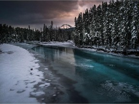 Partially frozen Bow River makes its way through Alberta's Banff National Park.