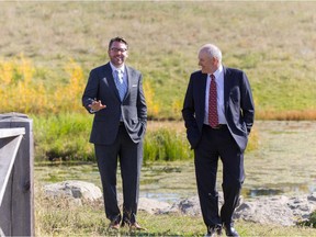Left, James Robertson, president and CEO, and Murray Fox, board chairman, of West Campus Development Trust at the pond that anchors the south end of the University District community on the edge of University of Calgary's campus.