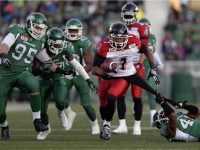 Saskatchewan Roughriders safety Tyron Brackenridge (#41) pulls on Calgary Stampeders wide receiver Lemar Durant's (#1) shirt during a game held at Mosaic Stadium in Regina, Sask. on Saturday Aug. 22, 2015.