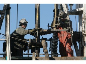 Crew work on a conventional drilling rig in Alberta.