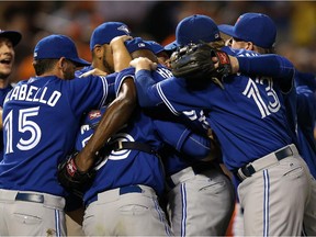 The Toronto Blue Jays celebrate after defeating the Baltimore Orioles and clinching the AL East Division during game one of a double header  in Baltimore Thursday. Reader admires Calgary pastor's intent to make the Jays part of his sermon.