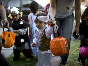 Children in costume during Halloween ready for the traditional trick-or-treating practice.