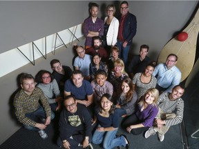 Wax Partnership's founding partners, Dan Wright, president, standing back right, Monique Gamache, design director, standing back centre, and Trent Burton, creative director, standing back left, pose with their staff at their office entryway for the company's ten year anniversary in Calgary, on Oct. 22, 2015.