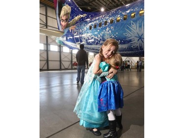 Ilaria Kotelko-Lange, 5 and her sister Leida, 3, are in love with WestJet's newest Walt Disney plane Frozen, that was unveiled in Calgary to Westjet employees on October 21, 2015.