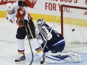 Winnipeg Jets goaltender Michael Hutchinson stops a shot from Calgary Flames' Drew Shore during the first period of a pre-season game on Thursday night.