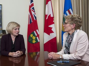 Ontario Premier Kathleen Wynne (right) meets with Alberta Premier Rachel Notley at Queen's Park in Toronto on Oct, 1, 2015.