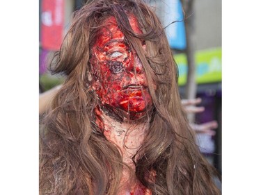 Dozens of the walking dead gather at Olympic Plaza to walk Stephen Ave and scare the living out of the living in Calgary, on October 17, 2015.