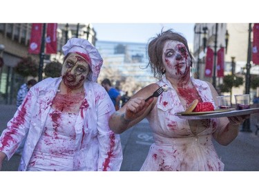 Dozens of the walking dead gather at Olympic Plaza to walk Stephen Ave and scare the living out of the living in Calgary, on October 17, 2015.