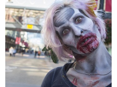 Dozens of the walking dead gather at Olympic Plaza to walk Stephen Ave and scare the living out of the living in Calgary, on October 17, 2015.