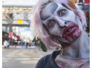 Dozens of the walking dead gather at Olympic Plaza to walk Stephen Ave and scare the living out of the living in Calgary, on October 17, 2015.