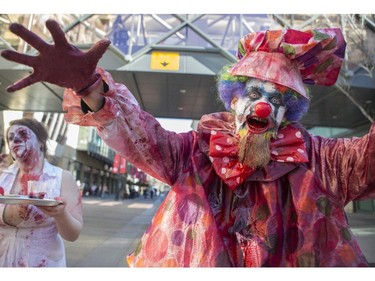 Dozens of the walking dead gather at Olympic Plaza to walk Stephen Ave and scare the living out of the living in Calgary, on October 17, 2015.