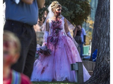 Dozens of the walking dead gather at Olympic Plaza to walk Stephen Ave and scare the living out of the living in Calgary, on October 17, 2015.