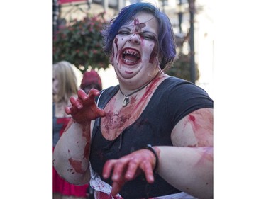 Dozens of the walking dead gather at Olympic Plaza to walk Stephen Ave and scare the living out of the living in Calgary, on October 17, 2015.