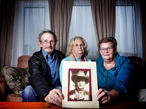 The children of David Day, who was killed in the CIL Explosives Plant explosion on April 21, 1975, pose with his photo. From left, Tom Day, Lorraine Barrett and Jeanette Cuthbert. Their sister Charlotte lives in Sherwood Park.