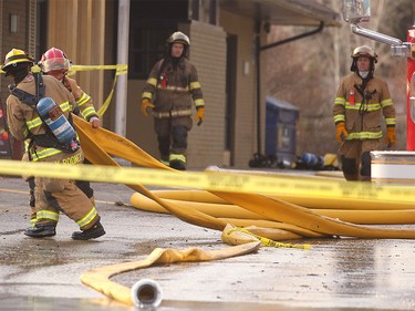 Members of the Calgary Fire Department moved hoses around after the roof collapsed during a two alarm fire at the Stadium Shopping Centre on Nov. 12.