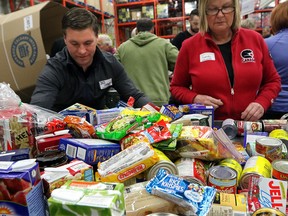 Volunteers Shawn Hanson and Sandy Jones help out the Calgary Food Bank on Nov. 17, 2015.