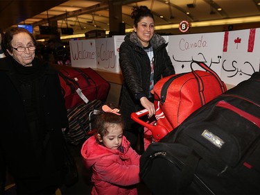 Syrian refugees arrive at the Calgary International Airport on Nov. 23, 2015.