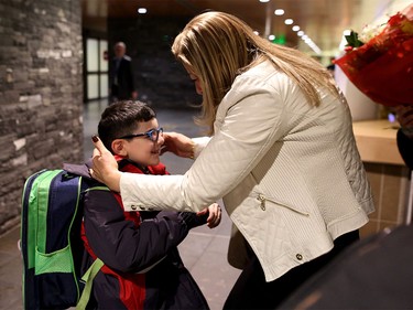 Laila Doumat, right, greets her nephew at the Calgary International Airport on Nov. 23, 2015.
