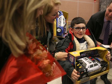 Syrian refugees are greeted by family members as they arrive at the Calgary International Airport on Nov. 23, 2015.